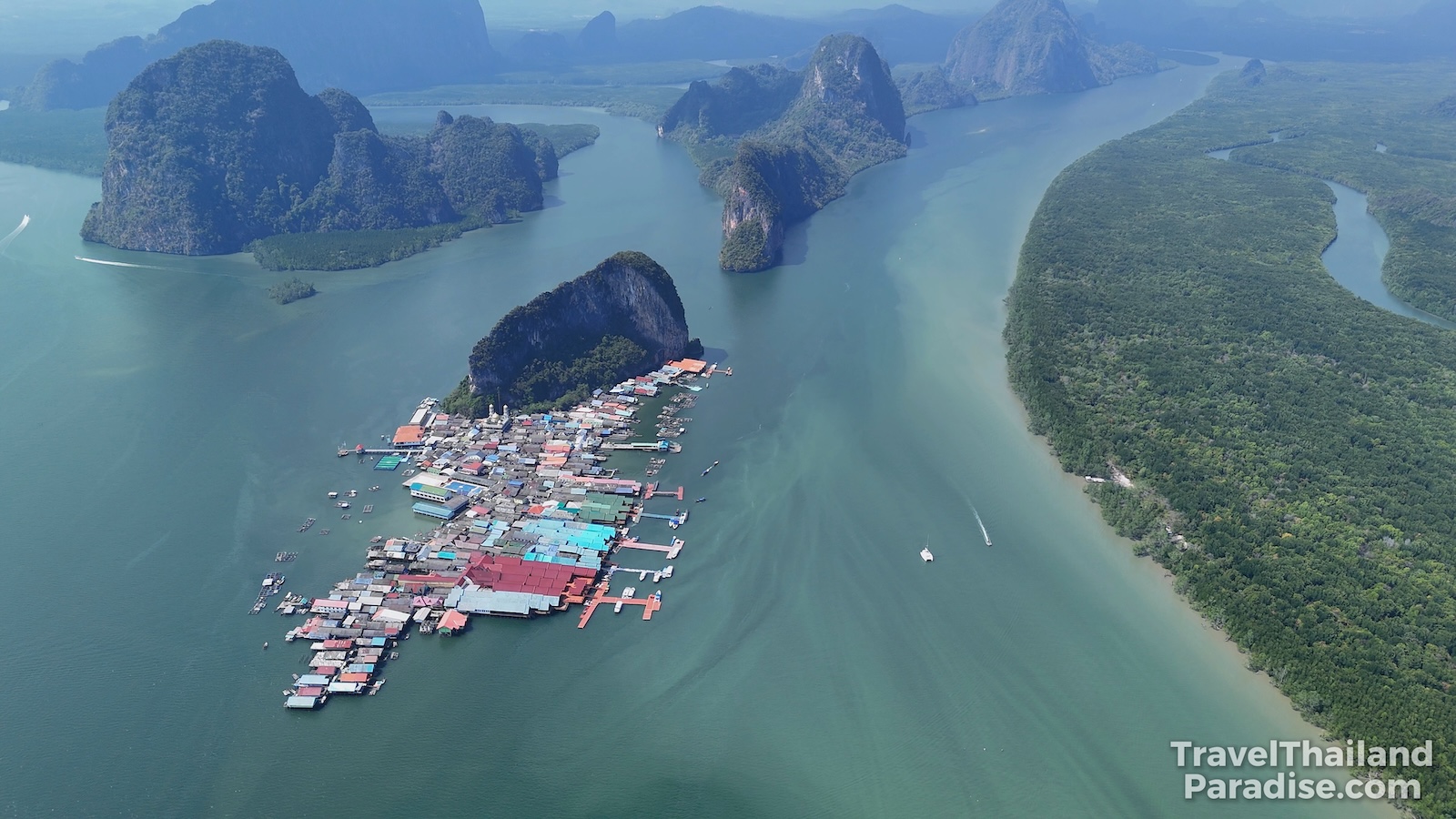 Aerial view of Koh Panyee Floating Village surrounded by limestone cliffs in Phang Nga Bay